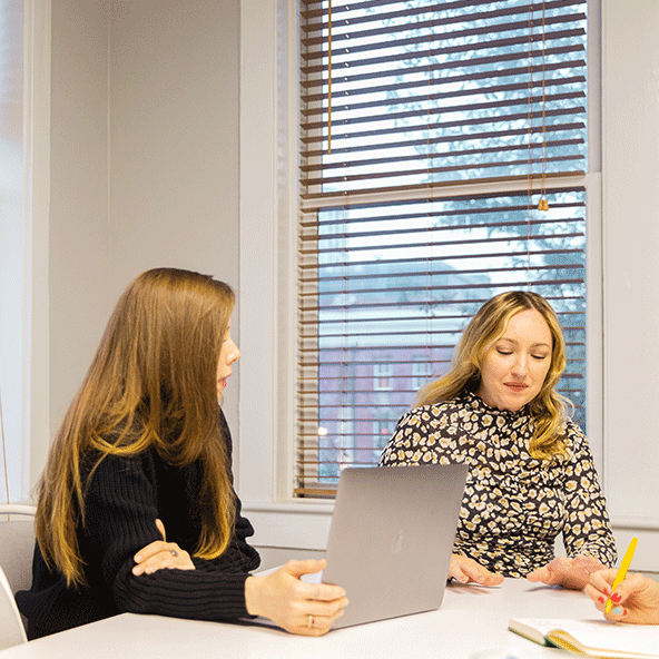 Photo of Focus Lab team members, Haley and Amy, meeting in a conference room.